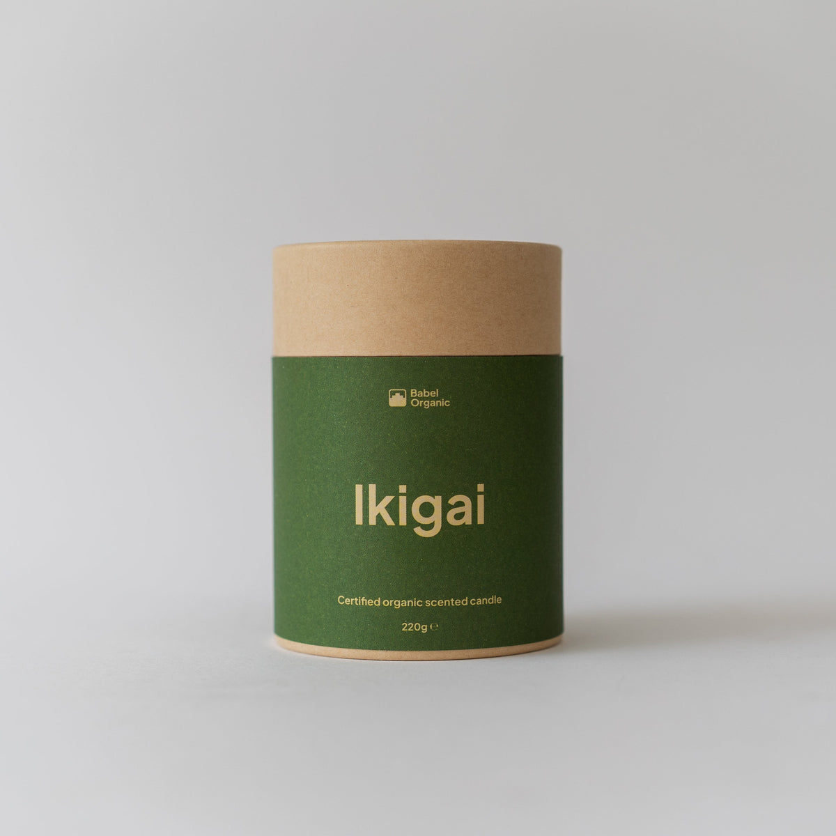 A cylindrical kraft paper canister with a dark green label reading 'Ikigai' in gold lettering, set against a plain light gray background.