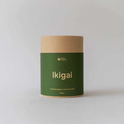 A cylindrical kraft paper canister with a dark green label reading 'Ikigai' in gold lettering, set against a plain light gray background.