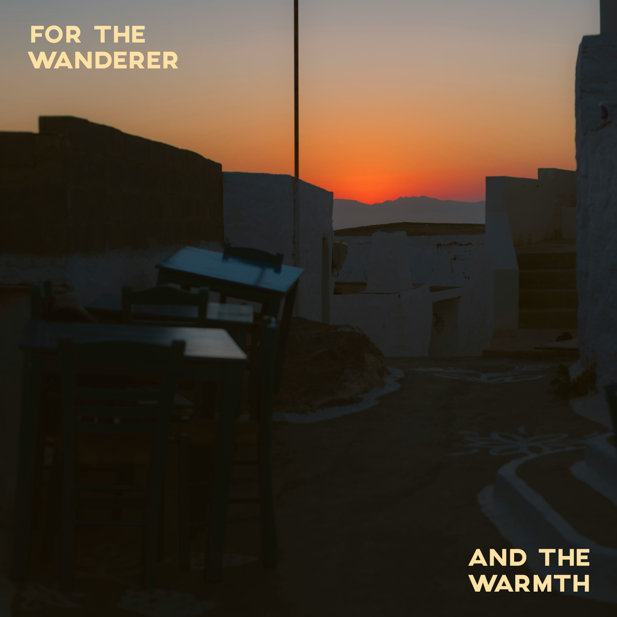 Sunset over a desert landscape with text 'For the Wanderer' and 'And the Warmth'.