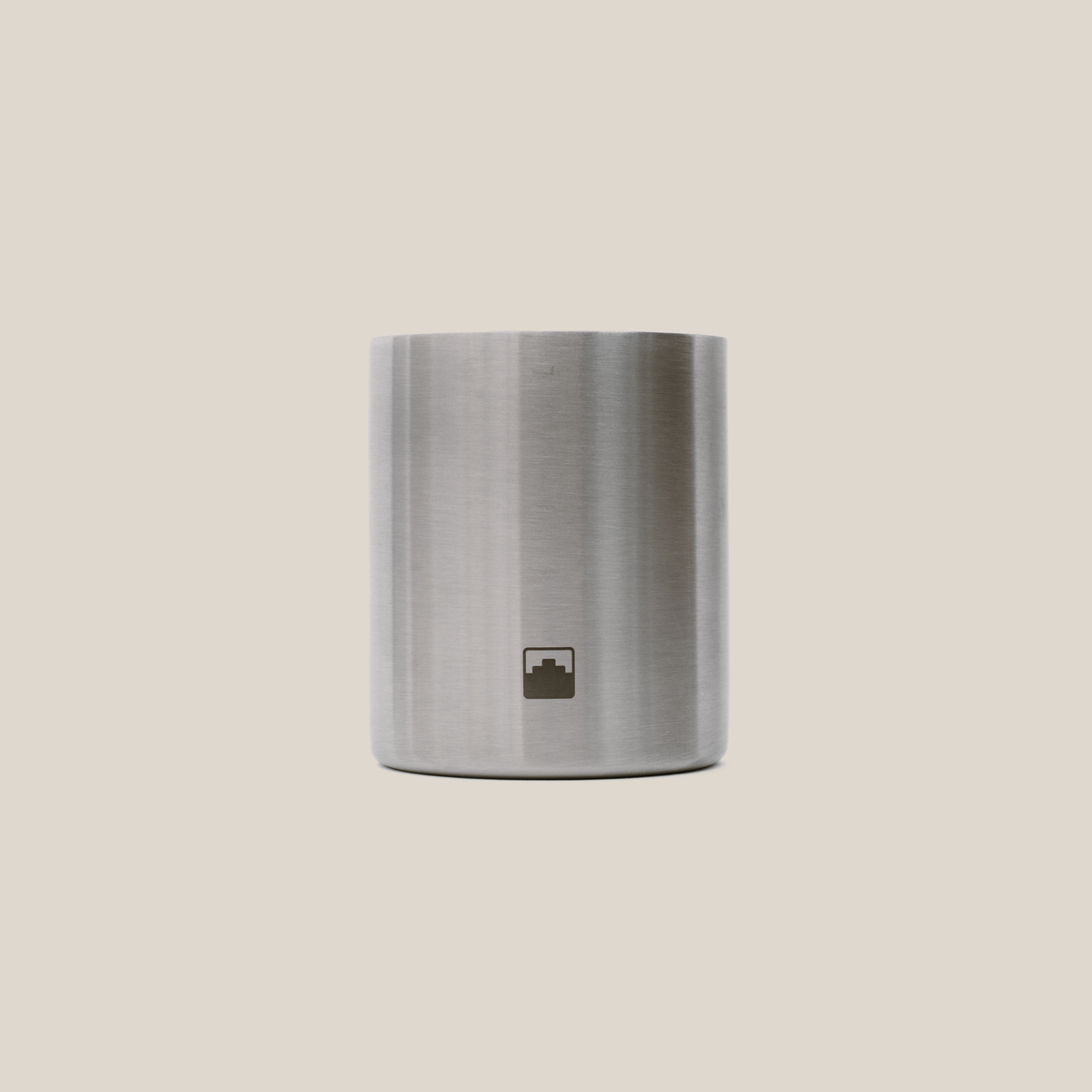 Stainless steel container with the Babel logo on a beige background