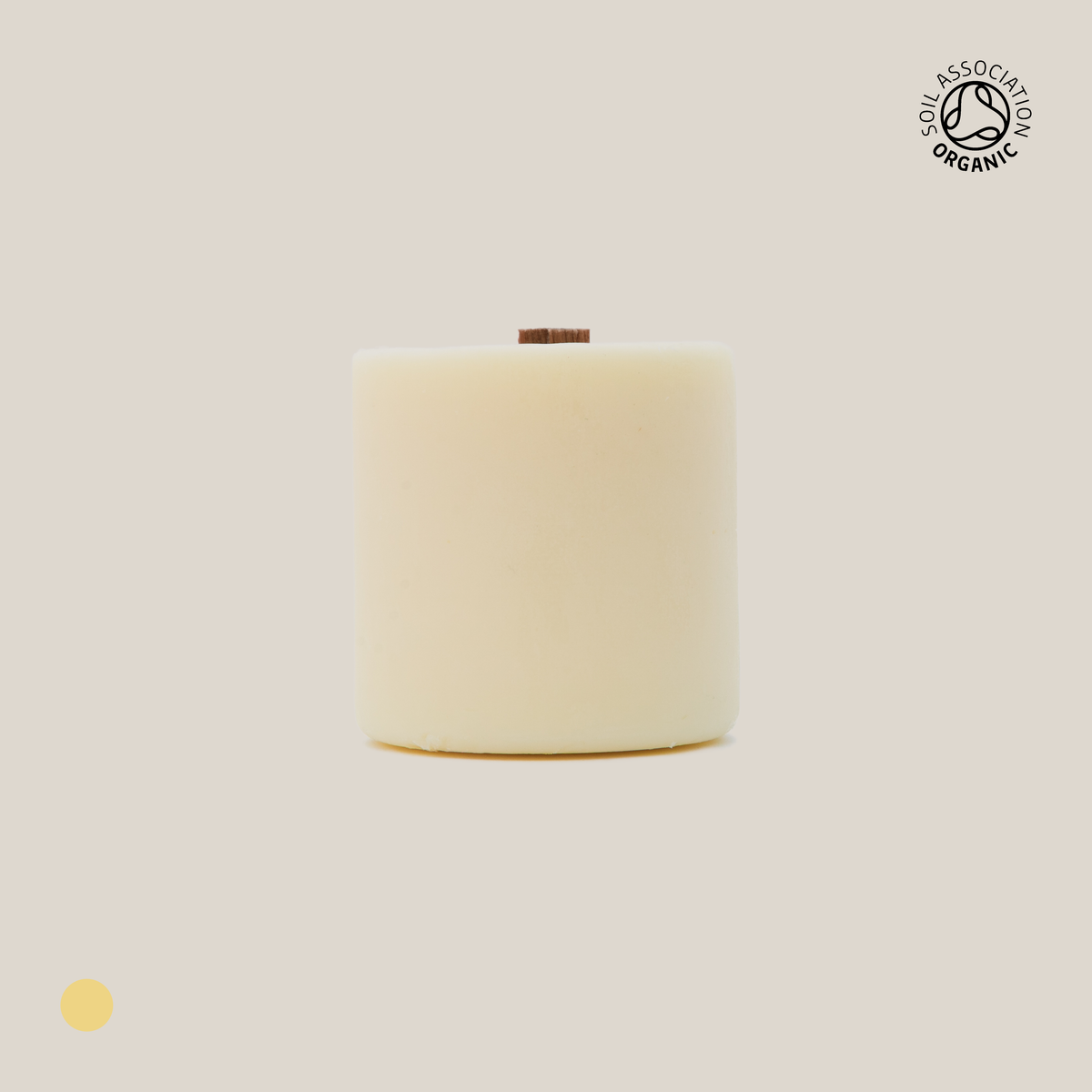 Beige cylindrical candle refill on a beige background with a visible Organic Certification logo
